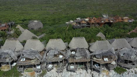 Aerial-flyback-over-Azulik-eco-lodge-at-Tulum,-Mexico