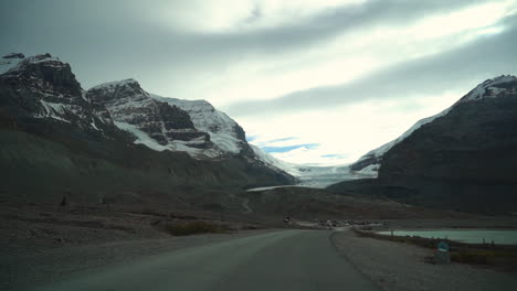 Driving-on-Road-to-Athabasca-Glacier-on-Moody-Cloudy-Day,-Alberta,-Canada,-Driver's-POV