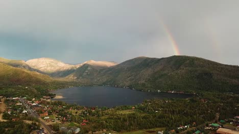 stunning-landscape-with-rainbow-in-the-sky-over-lake-and-mountain-range