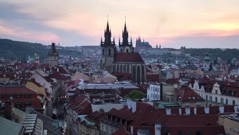 Day-to-night-sunset-timelapse-of-the-Prašná-Brána-,-Old-Town-Hall,-Prague-Castle-and-downtown-Prague,-Czech-Republic-as-it-lights-up-during-the-night