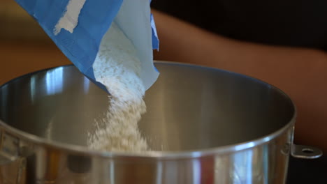 Shifting-flour-into-a-mixing-bowl-to-make-bread-dough---slow-motion
