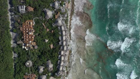 Aerial-top-down-rising-over-Azulik-resort-eco-lodge-at-Tulum,-Mexico