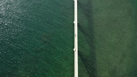 Long-pedestrian-bridge-on-emerald-waters-connecting-islets-to-mainland-in-Samana-Bay