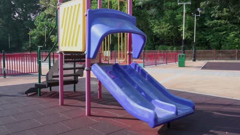 An-empty-purple-slide-on-a-children's-playground-is-seen-at-a-park-in-Hong-Kong