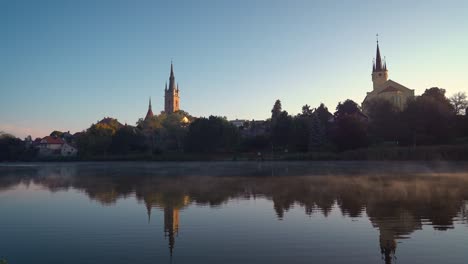czech-city-Caslav-seen-over-a-steaming-pond-in-the-morning,-static