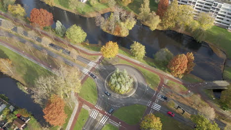 High-angle-view-of-a-busy-roundabout-in-the-Netherlands---drone-slowly-rising-up