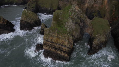 Ocean-Waves-Breaking-on-Scenic-Coast-of-Ireland,-Aerial-View-of-Nohoval-Cove,-Rock-and-Steep-Cliffs