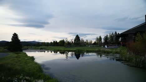 Small-Pond-Near-Country-House-At-Dusk---panning-shot