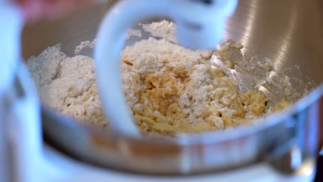 Mixing-ingredients-in-a-professional-stand-mixer-with-a-dough-hook---isolated-slow-motion