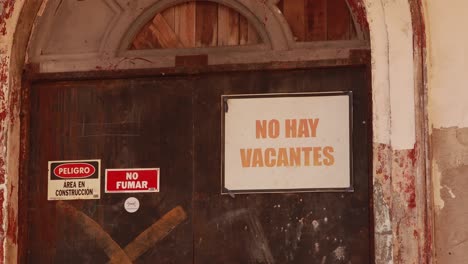 Not-hiring-sign-taped-to-an-old-big-entrance-door-to-a-historic-building-in-which-restoration-and-construction-work-is-being-done,-displaying-the-lack-of-job-opportunities-created-by-the-pandemic