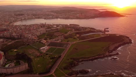 Drone-fly-above-la-coruna-city-in-north-of-Spain-Galicia-autonomous-region,-aerial-cityscape-at-sunset