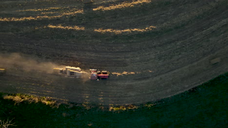 Top-Down-Aerial-Following-Tractor-Baling-Corn-Stalks-In-In-Rural-Pennsylvania,-U