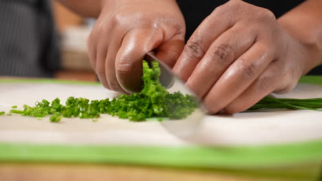Chopping-green-chives---an-ingredient-for-a-homemade-savory-recipe---isolated-in-slow-motion