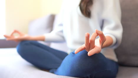 Depth-of-field-Close-up-of-a-woman's-body-and-hands-while-sitting-in-the-lotus-position