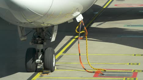 Close-up-of-cables-connected-to-an-airplane-during-maintenance