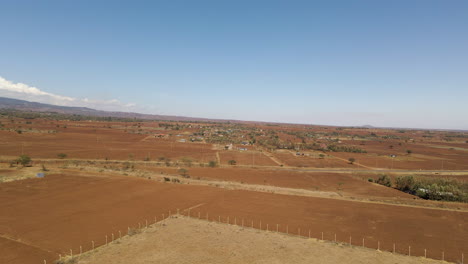 Jib-up-of-an-arid-landscape-in-rural-Kenya-with-a-small-village-in-the-distance
