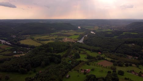 Aerial-sunset-footage-of-Beynac-et-cazenac-france-medieval-small-stone-village-in-the-dordogne-forest-wood-region-south
