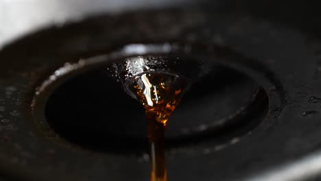 A-close-up-view-of-coffee-flowing-with-bubbles