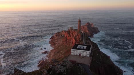 Lighthouse-aerial-sunset-view,-Galicia-north-Spain-coastline-region-Atlantic-sea-ocean-Cabo-vilan
