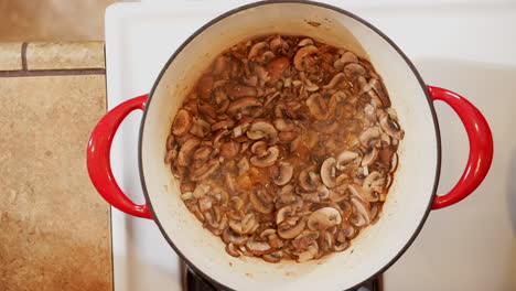 Overhead-view-of-mushrooms-sautéing-in-a-pot-on-the-stove---Dutch-oven-cooking-mushrooms
