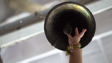 baby-girl-ringing-bell-in-temple-Indian