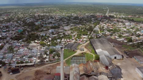 Aerial-flyback-over-Porvenir-sugar-mill,-San-Pedro-de-Macoris-in-Dominican-Republic