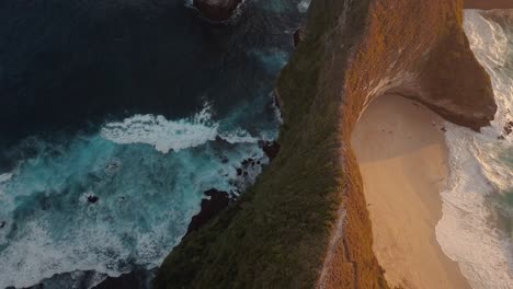 drone-shot-flying-over-the-beach-of-crystal-bay-at-sunset-with-the-camera-facing-down,-Nusa-Penida,-Indonesia-in-4k