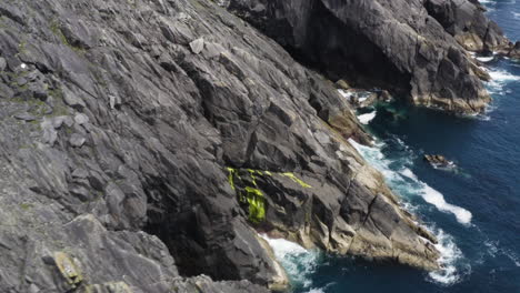 AERIAL---Rocky,-dangerous-cliffs-in-Dingle,-County-Kerry,-Ireland,-spinning-shot
