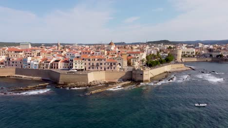 4K-clip-moving-along-the-coastline-and-the-walls-of-the-Alghero-town-in-Sardinia,-Italy