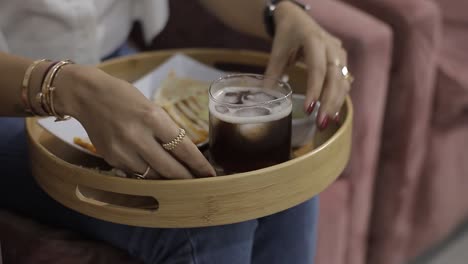girl-sitting-in-beauty-salon-drinking-iced-tea-on-a-wooden-tray