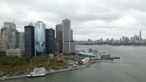 Aerial-view-around-the-Whitehall-Terminal-in-lower-Manhattan,-in-cloudy-NY,-USA---circling,-drone-shot