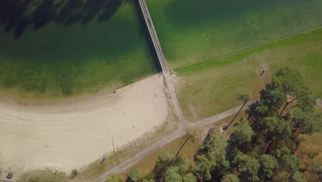Aerial-drone-view-of-the-small-bridge-at-the-recreational-lake-in-the-Netherlands,-Europe