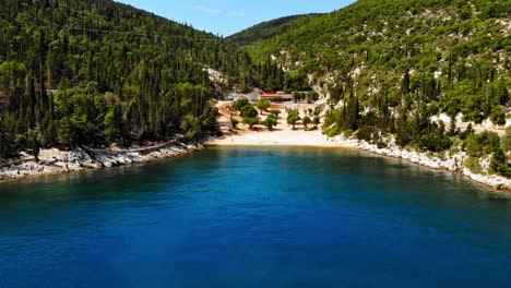 Calm-Blue-Waters-And-Scenic-View-Of-Foki-Beach-In-Greece---aerial-shot