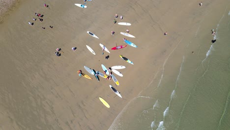 Aerial-top-down-of-Standup-Paddle-Boarders-gathering-on-beach-for-racing-event