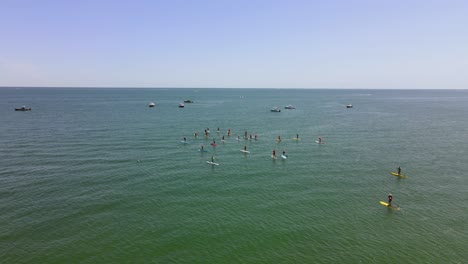 Aerial-view-of-Standup-Paddle-Boarding-race-on-waters-of-Rexhame-beach,-Marshfield