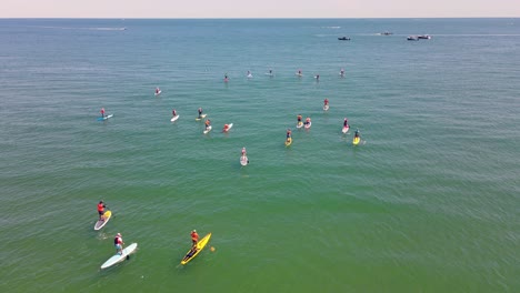 Recreational-sport-of-Standup-Paddle-Boarding-showing-paddleboarders-race-at-Rexhame-beach,-Marshfield