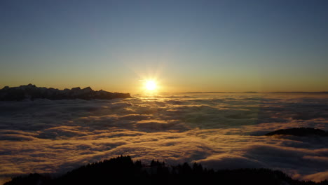 Bright-Sun-At-Sunset-Shining-Over-Sea-Of-Clouds-And-Le-Folly-Summit-In-Prealps,-Vaud,-Switzerland