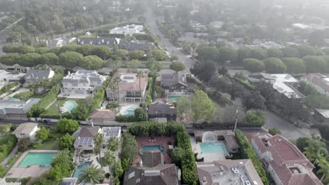 Top-down-aerial-shot-flying-over-Beverly-Hills-city-in-early-morning-fog