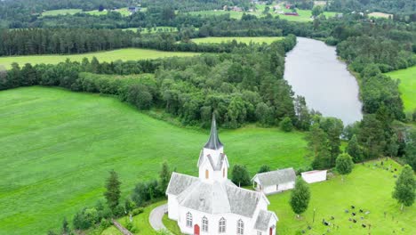 Charming-Old-Architecture-Of-Eikesdal-Church-And-Houses-In-A-Small-Town-By-The-Kattammaren-Mountain---Aerial-shot