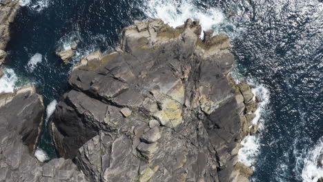 AERIAL---Cliffs-next-to-the-ocean,-Dingle,-County-Kerry,-Ireland,-forward-top-down