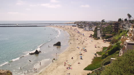 People-Enjoying-Corona-Del-Mar-State-Beach-Park-On-A-Sunny-Day-From-Inspiration-Point-Lookout-In-California,-USA