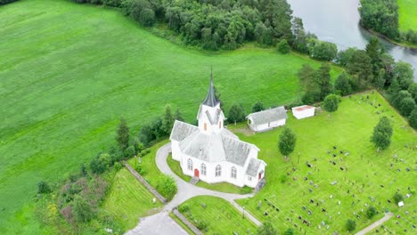 Peaceful-Church-By-The-Cemetery-In-Romsdal-County-Norway---aerial-shot