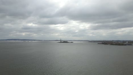 Aerial-drone-view-towards-the-statue-of-Liberty,-in-New-York,-USA---bird-in-frame