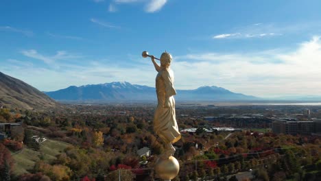 Angel-Moroni-Gold-Statue-with-Trumpet-on-Provo-LDS-Mormon-Temple,-Extremely-Detailed-Aerial-Closeup