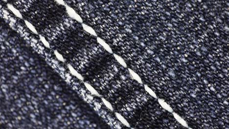 White-straight-stitches-across-denim-fabric--Macro