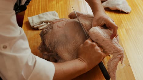 Chef-cutting-Turkey-on-wooden-cut-board