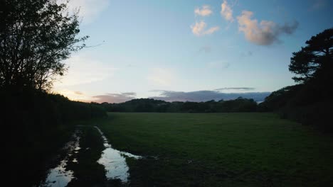 4K-Cinematic-landscape-shot-of-an-empty-field-just-after-a-beautiful-sunset