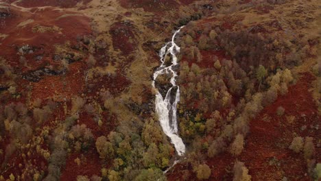 AERIAL---Ben-Glas-burn-waterfall,-Glencoe,-Scottish-Highlands,-Scotland,-pan-left