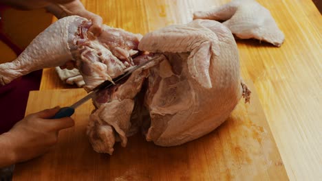 Butchering-turkey-on-wooden-cut-board