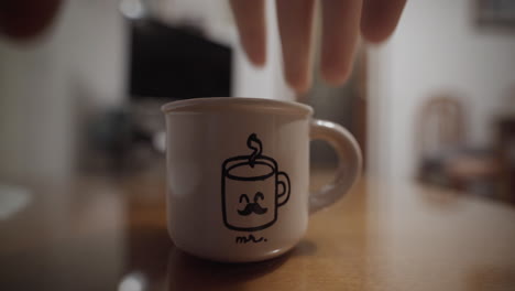 Dear-cute-mustache-coffee-character-mug-being-picked-up